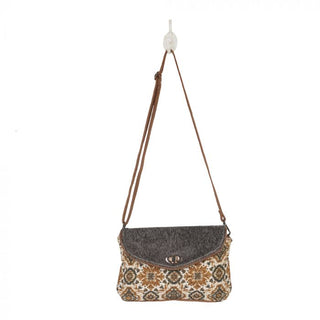 Flap-over handbag with patterned front and gray top, on a white background