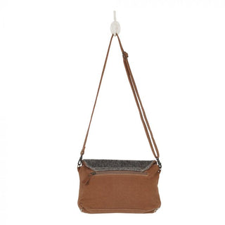 Flap-over handbag with patterned front and gray top, on a white background