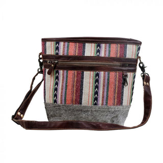 Multicolored striped bag with a gray base and brown straps on a white background