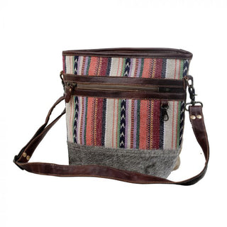 Multicolored striped bag with a gray base and brown straps on a white background