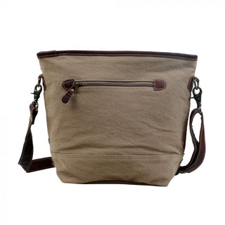 Multicolored striped bag with a gray base and brown straps on a white background