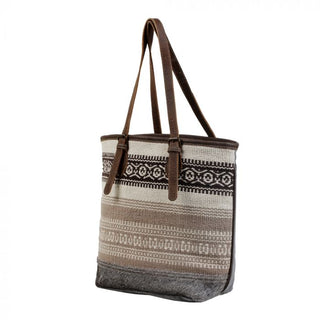 Tote bag with patterned design and brown straps on a white background