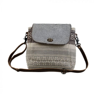 Gray and patterned fabric crossbody bag on a white background