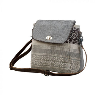 Gray and patterned fabric crossbody bag on a white background