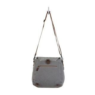Gray and patterned fabric crossbody bag on a white background